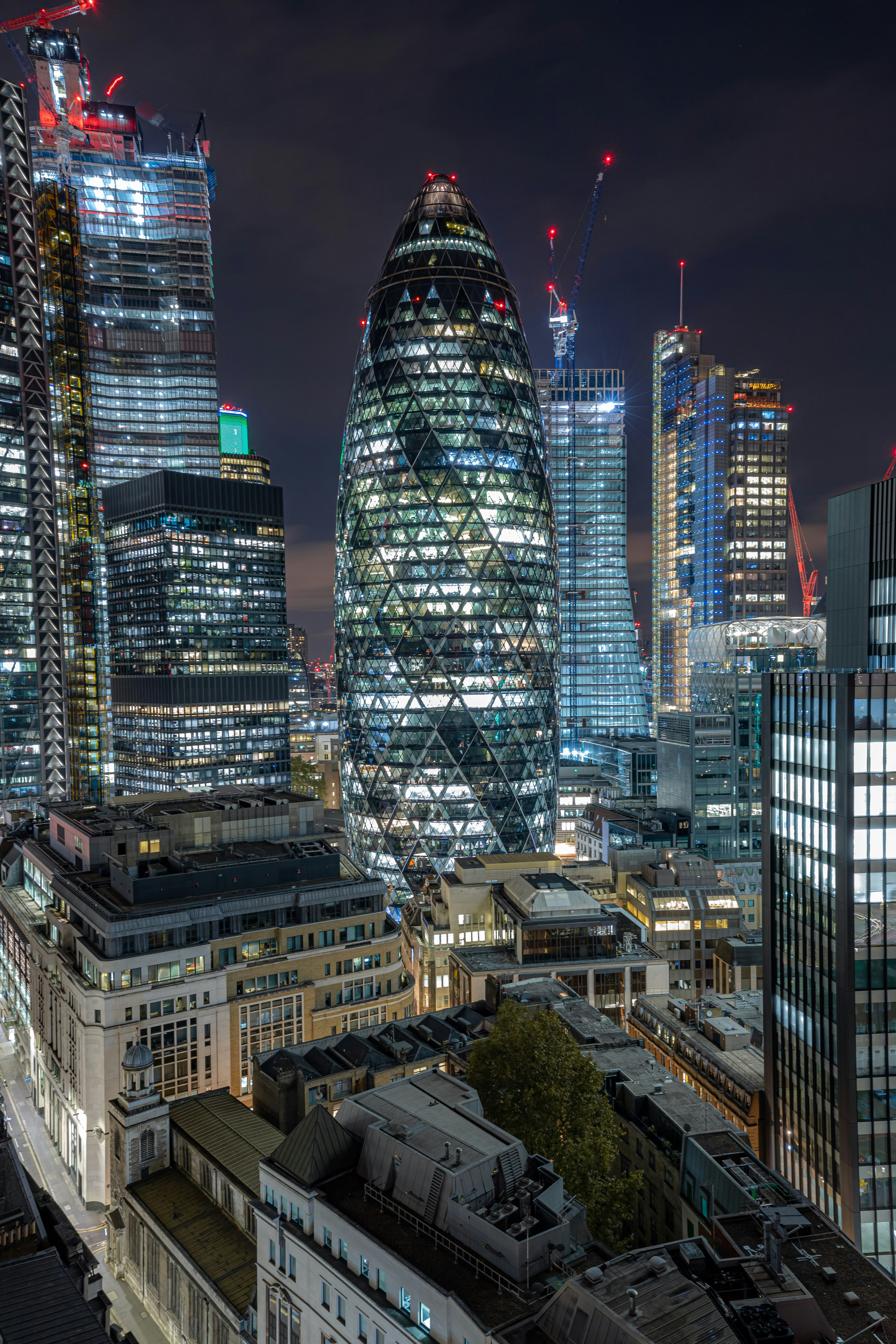 city buildings with lights turned on during night time